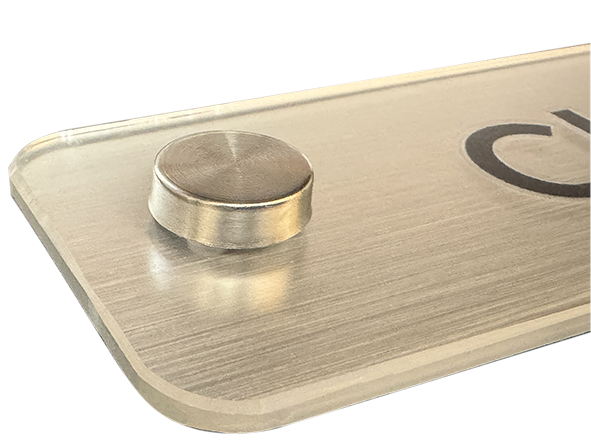 Close up detailed picture showing a brushed silver Operational sign fitting and chamfered edge