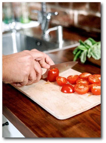 Dementia-friendly reminiscence image of chopping up fresh tomatoes. 