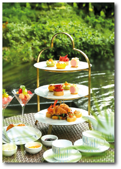 Dementia-friendly reminiscence artwork of a three-tiered stand filled with cakes and pastries for an afternoon cream tea.