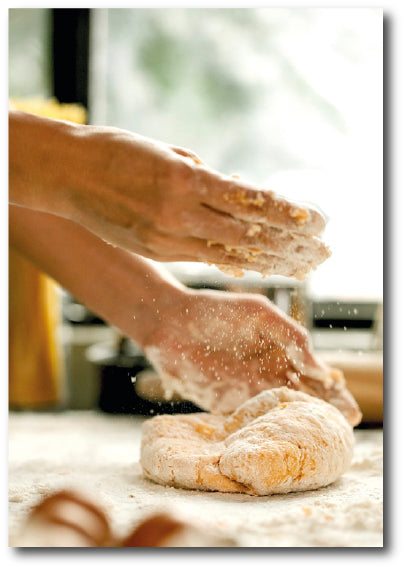 Dementia-friendly reminiscence image of hands preparing a plain scone mix for rolling out and cutting ready to bake.